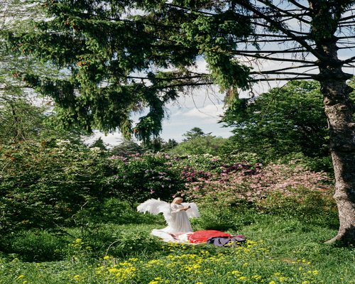 Active mature woman practicing morning yoga in the garden